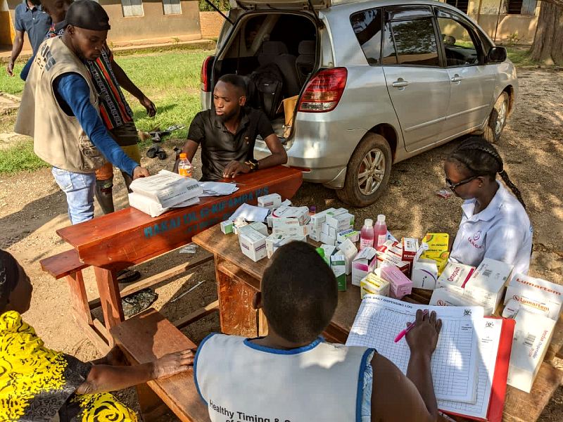 The MANCO team unpacks supplies from a car at the start of an outreach day