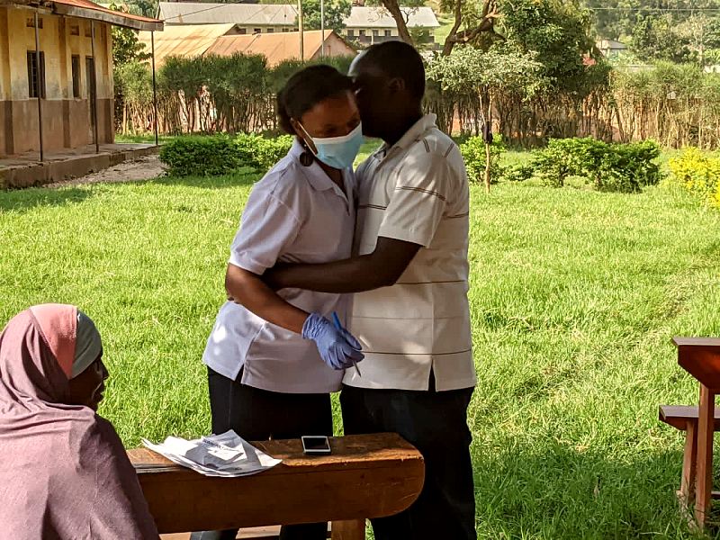 Two MANCO team members hug at an outreach site